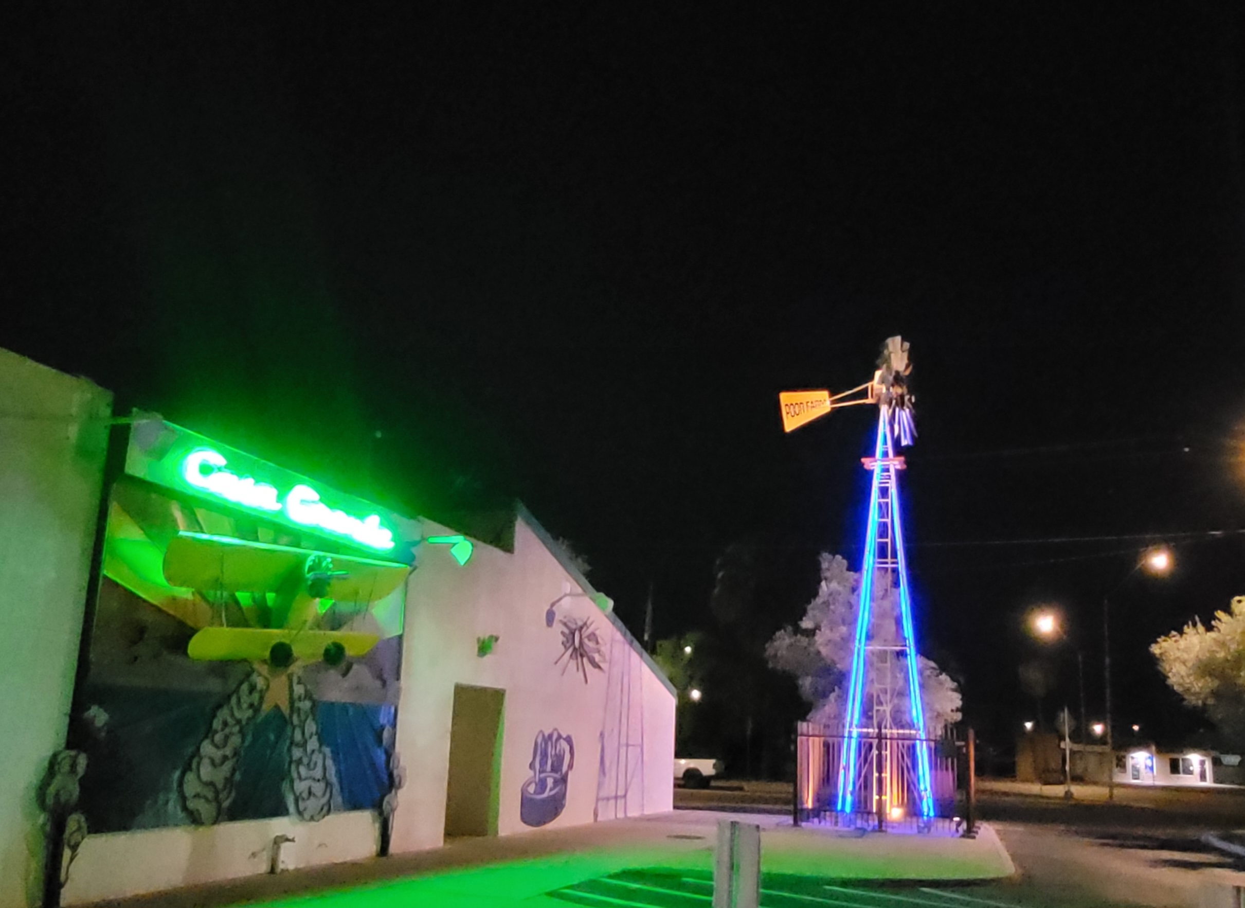 Windmill Roadside Attraction at Night with Crop Duster